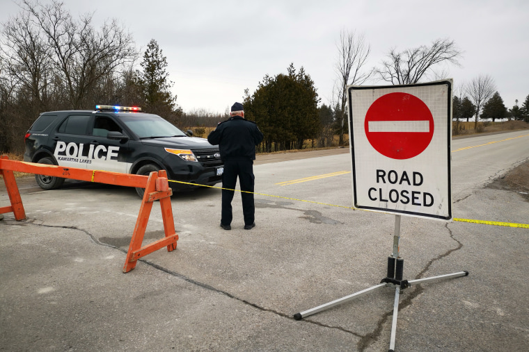 A special constable with the Kawartha Lakes Police Services stands at a road block in Kawartha Lakes, Ont., on Nov. 27, 2020.