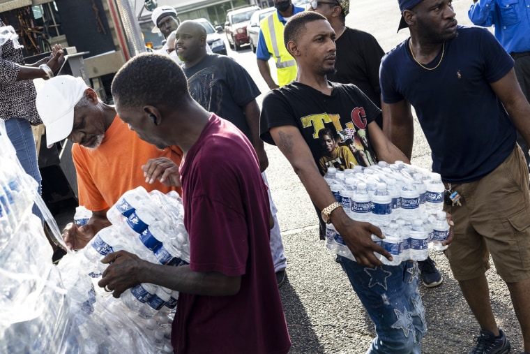 Cases of bottled water are handed out at a Mississippi Rapid Response Coalition distribution site