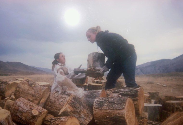 Sophia Boutrous, left, and Kelsie VanMeveren lift lumber at Trinity Teen Solutions in 2011. According to former residents, girls at the ranch were given film cameras and allowed to take photos, but Trinity Teen Solutions had discretion over which images were given back to the girls.