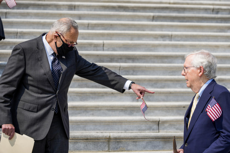 Image: Senate Majority Leader Chuck Schumer (D-NY) points at Senate Minority Leader Mitch McConnell as they arrive for a remembrance ceremony marking the 20th anniversary of the 9/11 terror attacks on the steps of the U.S. Capitol, on September 13, 2021 in Washington, DC.
