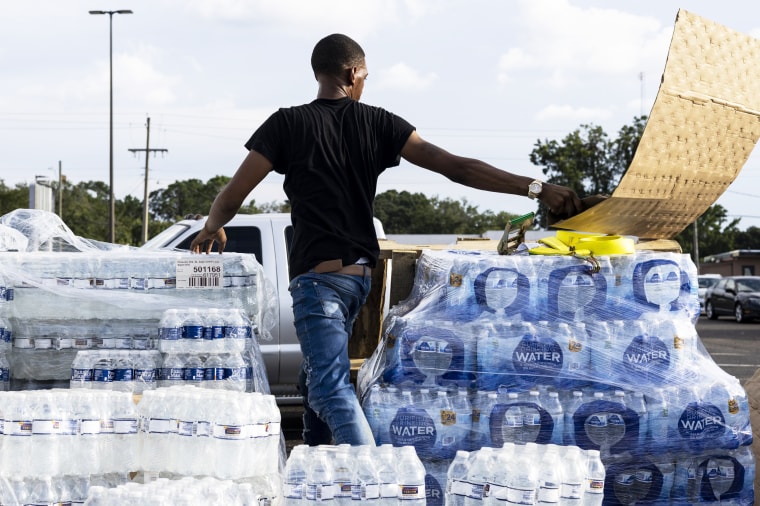 Cases of bottled water are handed out at a Mississippi Rapid Response Coalition distribution site