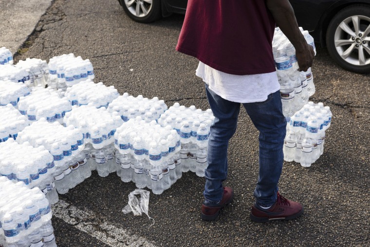 Cases of bottled water are handed out at a Mississippi Rapid Response Coali...