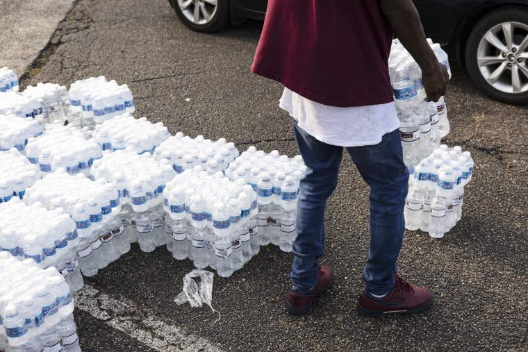 Cases of bottled water are handed out at a Mississippi Rapid Response Coalition distribution site