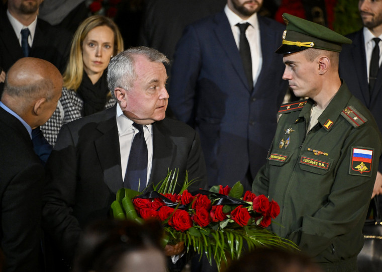 U.S. ambassador to Russia John Joseph Sullivan, center, walks to the coffin of former Soviet President Mikhail Gorbachev inside the Pillar Hall of the House of the Unions during a farewell ceremony in Moscow on Sept. 3, 2022.