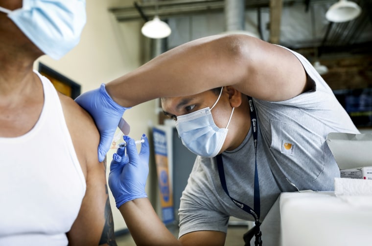 A registered nurse administers a Covid-19 booster dose in Los Angeles on Aug. 23, 2022.