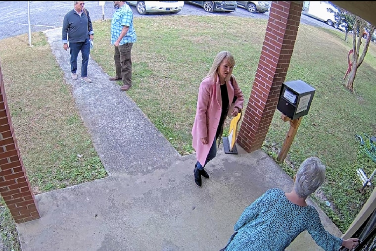 Cathy Latham, bottom, who was the chair of the Coffee County Republican Party at the time, greets a team of computer experts from the data solutions company SullivanStrickler at the county elections office in Douglas, Ga., on Jan. 7, 2021.