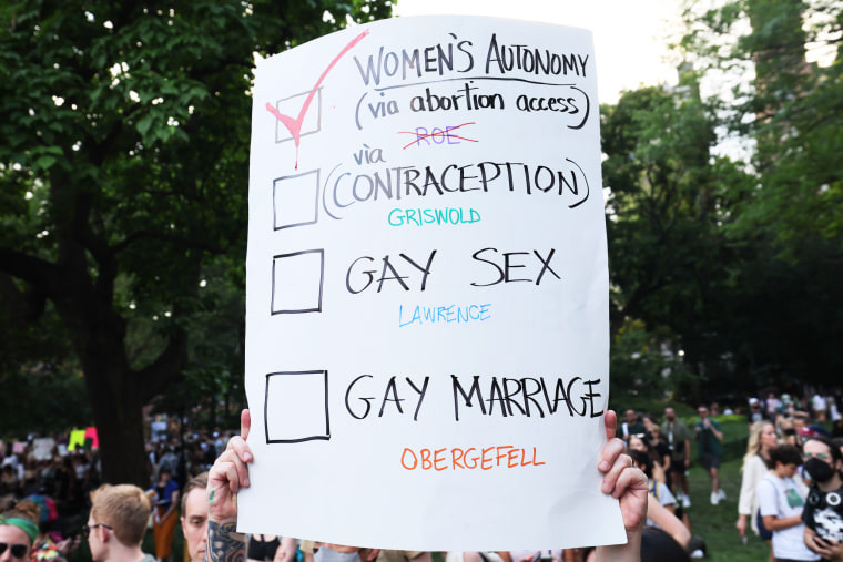 A person holds up a protest sign