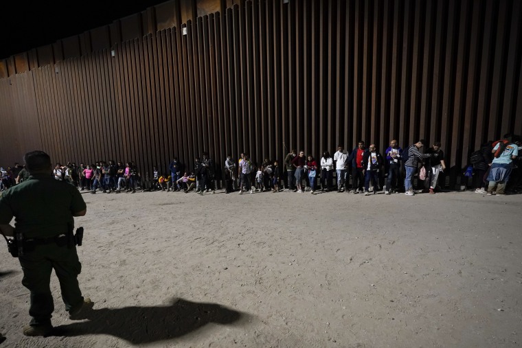Migrants wait to be processed by Border Patrol agents