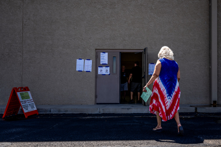 A person walks to cast a ballot in Phoenix on Aug. 2, 2022.