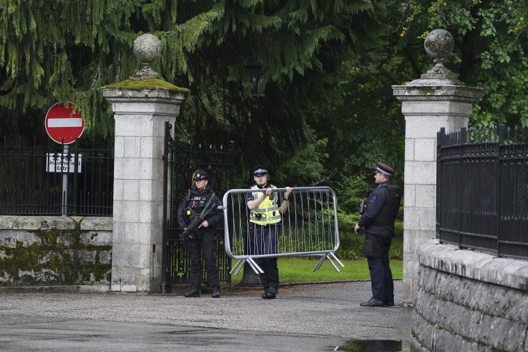 Barriers are moved into place at the entrance to Balmoral Castle in Scotland on Thursday. 