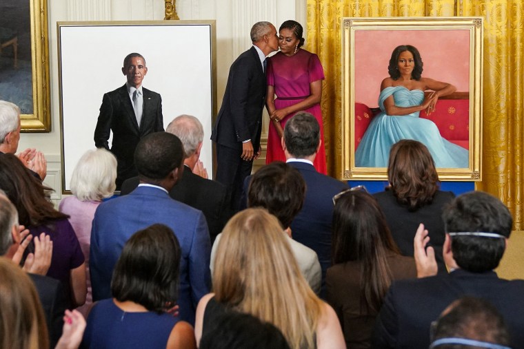 Former President Barack Obama kisses former First Lady Michelle Obama during a ceremony to unveil their official White House portraits in the East Room on Sept. 7, 2022.