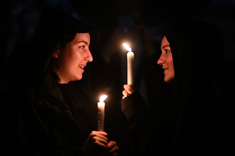 Image: Well-wishers leave candles outside Buckingham Palace, after the announcement of the death of Queen Elizabeth II on Thursday.