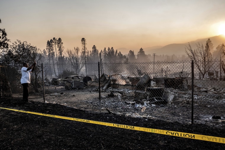 Dave Rodgers surveys his home, destroyed by the Mill Fire, on Saturday, Sept. 3, 2022, in Weed, California. Rodgers, who lived in the house his entire life, was able to take an elderly neighbor with him as he fled the fast-moving blaze but has not been able to find his two dogs that were left behind.