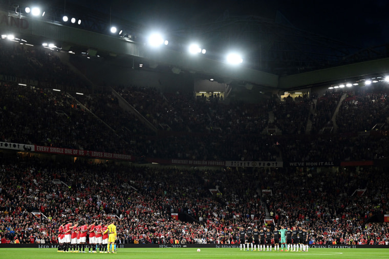 Image: The teams pose for a moment's silence following the death of Queen Elizabeth II, ahead of the UEFA Europa League Group E football match between Manchester United and Real Sociedad, at Old Trafford stadium, in Manchester, on Sept. 8, 2022.