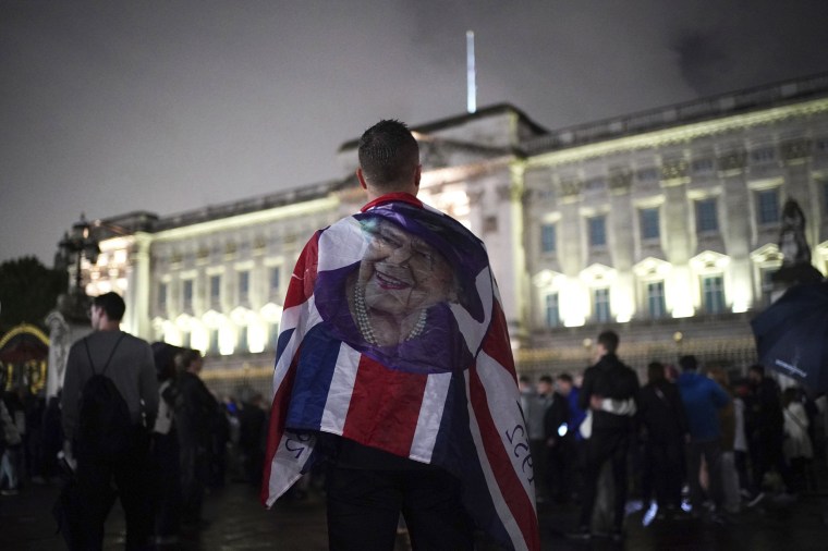 Image: Mourners gather outside Buckingham Palace following the announcement of the death of Queen Elizabeth II on Thursday.