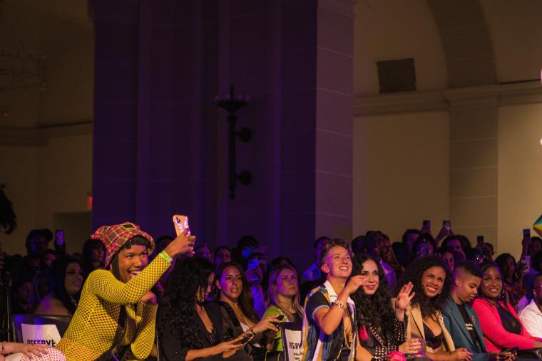 Attendees celebrate during the dapperQ fashion show