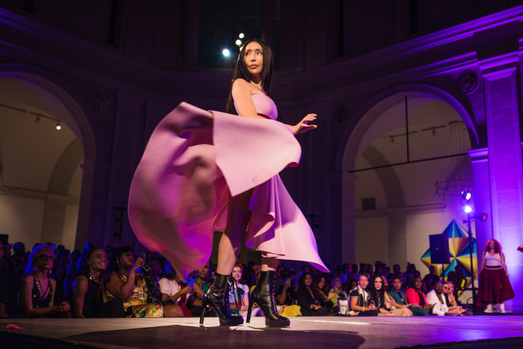 A model walks the runway during dapperQ fashion show