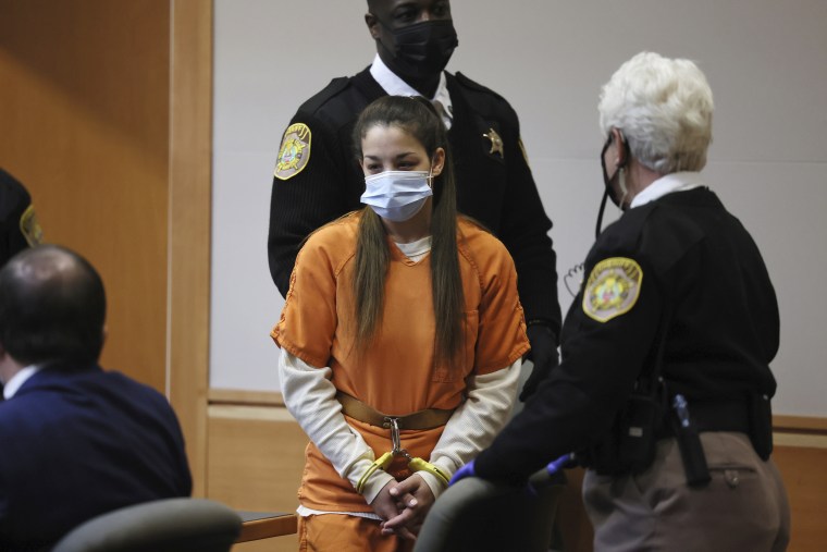 Kayla Montgomery, center, stepmother of missing girl Harmony Montgomery, is escorted into Hillsborough County Superior Court North, in Manchester, N.H., on Jan. 24, 2022.