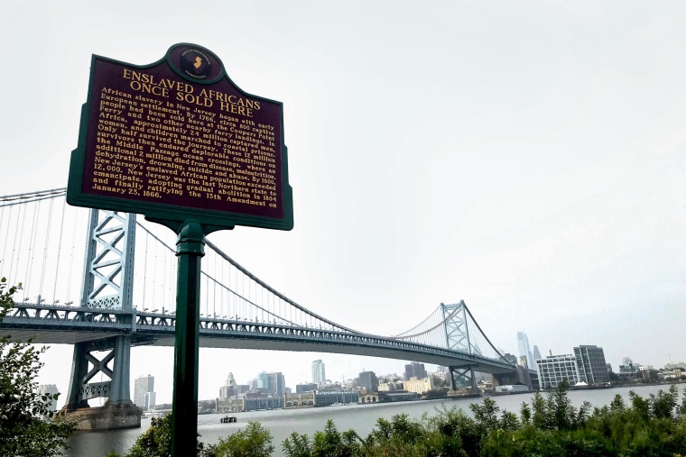 A marker reads "Enslaved Africans once sold here," commemorating a site where slaves were bought and sold on the Camden, N.J.,  waterfront in 2020.