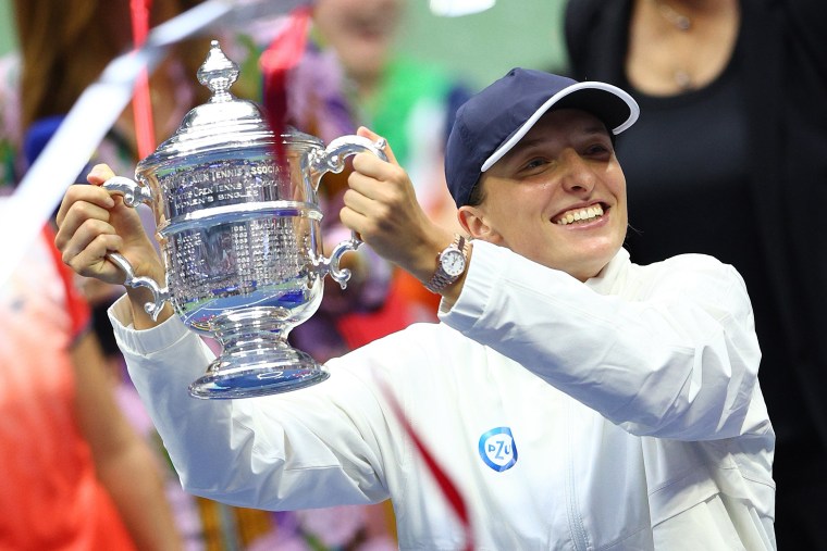 Iga Swiatek of Poland celebrates with the championship trophy Friday, Sept. 10, 2022, after winning the Women’s Singles Final match at the 2022 U.S. Open.