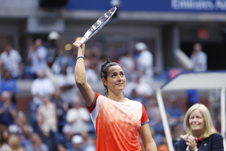 Ons Jabeur of Tunisia celebrates with the runner-up trophy after being defeated by Iga Swiatek at the 2022 U.S. Open on Sept. 10, 2022.