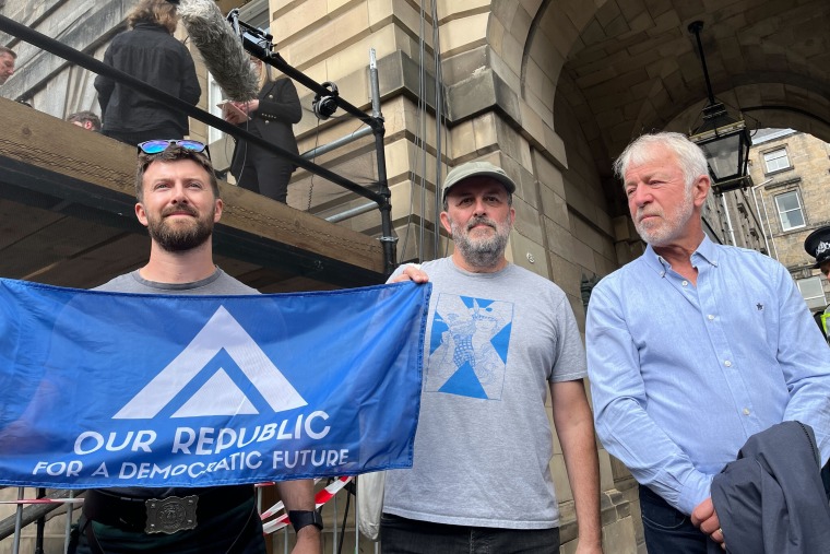 John Hall, left, and several other protesters who did not wish to give their names.