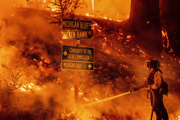 A firefighter battles the Mosquito Fire in Placer County, Calif., on Sept. 7, 2022.