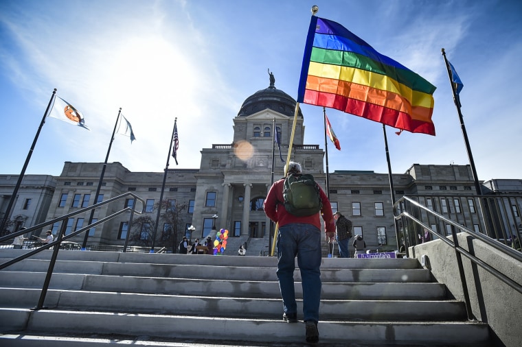 Demonstrators gather on the steps of the Montana State Capitol to protest anti-LGBTQ+ legislation on March 15, 2021.