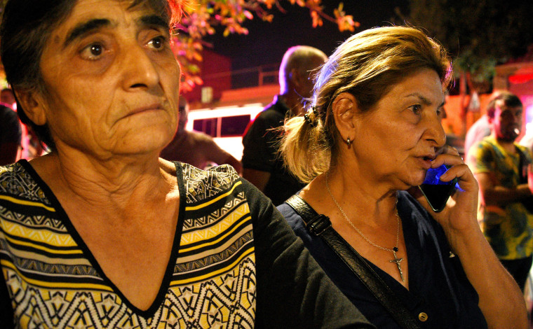 Relatives of servicemen, who were wounded in night border clashes between Armenia and Azerbaijan, gather outside a military hospital in Yerevan on Tuesday.