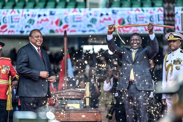 Image: Outgoing Kenya President Uhuru Kenyatta looks on as President William Ruto lifts a sword at the Moi International Sports Center Kasarani in Nairobi, Kenya, on Sept. 13, 2022 during the inauguration ceremony.