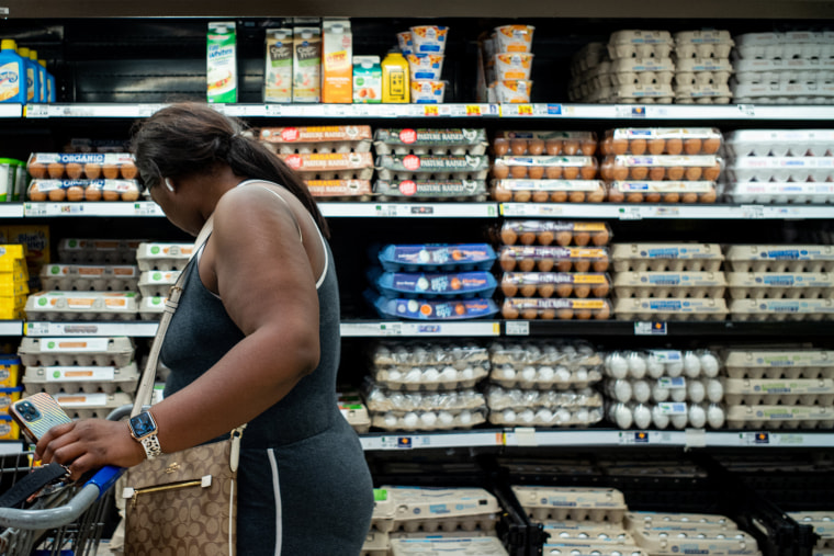 A customer shops for eggs in a Kroger grocery store