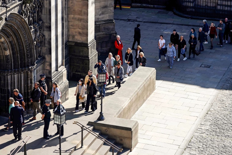 Image: Members of the public queue to enter St Giles' Cathedral, in Edinburgh, on Sept. 13, 2022, to pay their respects before the coffin of Queen Elizabeth II lying at rest.