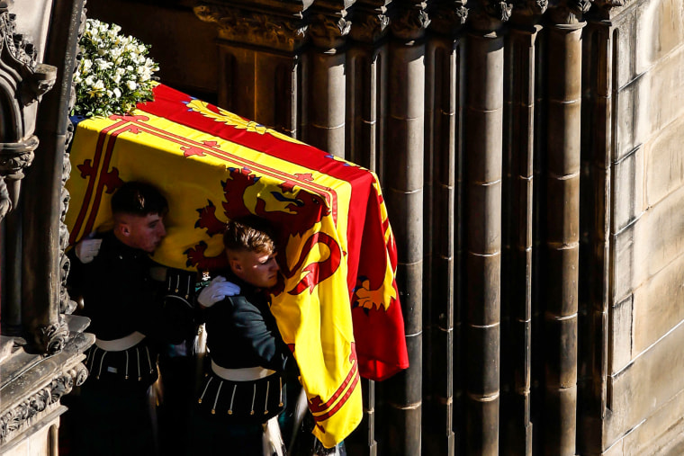 Image: Pallbearers carry the coffin of Queen Elizabeth II from St Giles' Cathedral in Edinburgh on Sept. 13, 2022 to a hearse to be transported to Edinburgh airport.