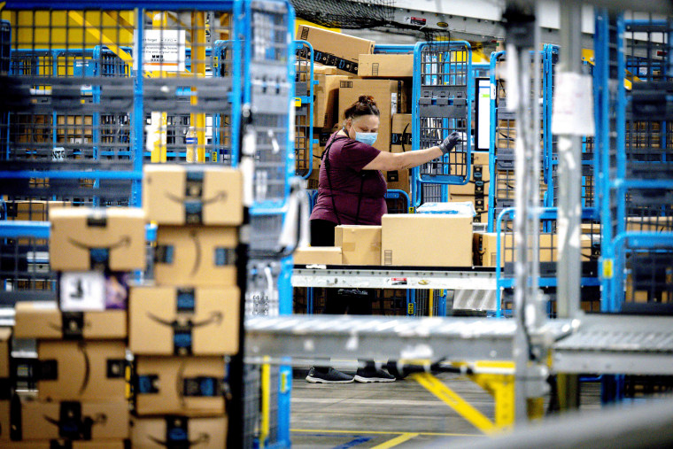 A worker sorts out packages at an Amazon fulfillment center