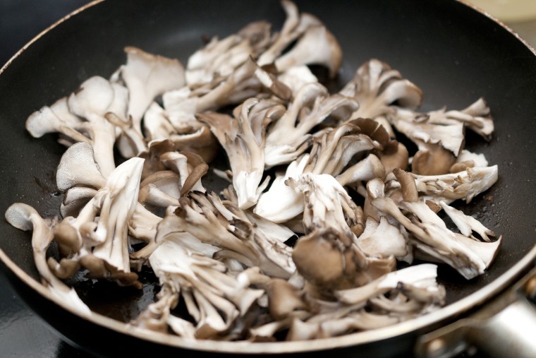 Stir-fry the maitake mushrooms in a frying pan