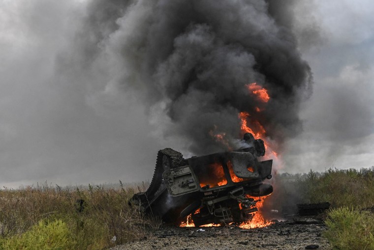 A destroyed Russian MT-LB armored personnel carrier burns in a field on the outskirts of Izyum, Kharkiv Region, eastern Ukraine, on Sept. 14, 2022.