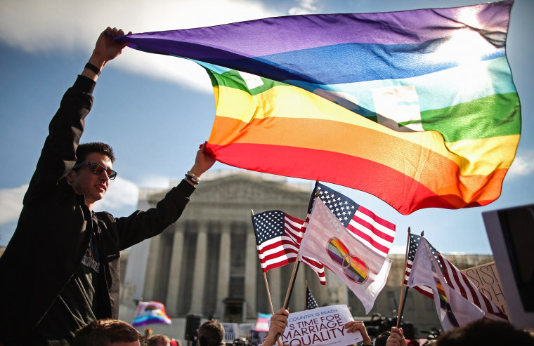 People rally in support of marriage equality outside the Supreme Court during oral arguments in a case challenging the Defense of Marriage Act on March 27, 2013.