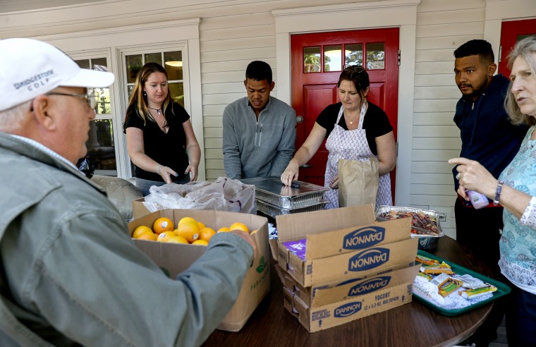 Volunteers help serve food to the recently arrived migrants on Martha's Vineyard, Mass., on Sept. 15, 2022.
