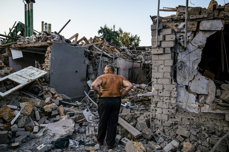 Oleksandr Shulga looks at his destroyed house following a missile strike in Mykolaiv, Ukraine, on Aug. 29, 2022.