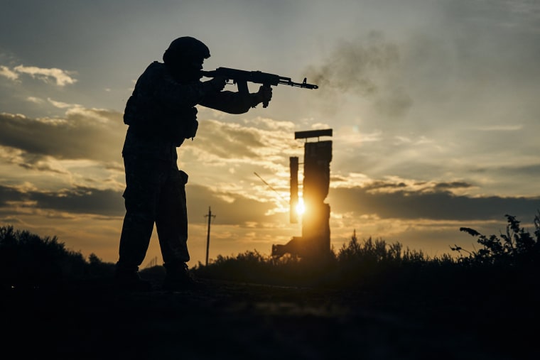 A Ukrainian soldier shoots close to Izium, Kharkiv region, on Sept. 13, 2022.