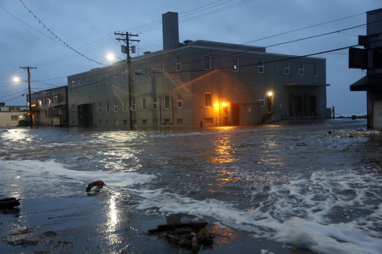 Water rushes down Front Street, just a half block from the Bering Sea, in Nome, Alaska, on Saturday, Sept. 17, 2022.