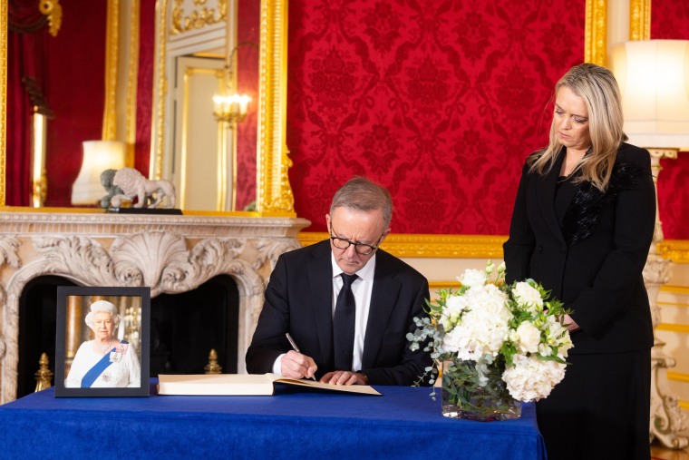 Image: Prime Minister of Australia, Anthony Albanese, and his partner Jodie Haydon sign a book of condolence at Lancaster House following the death of Queen Elizabeth II, on Sept. 17, 2022 in London.