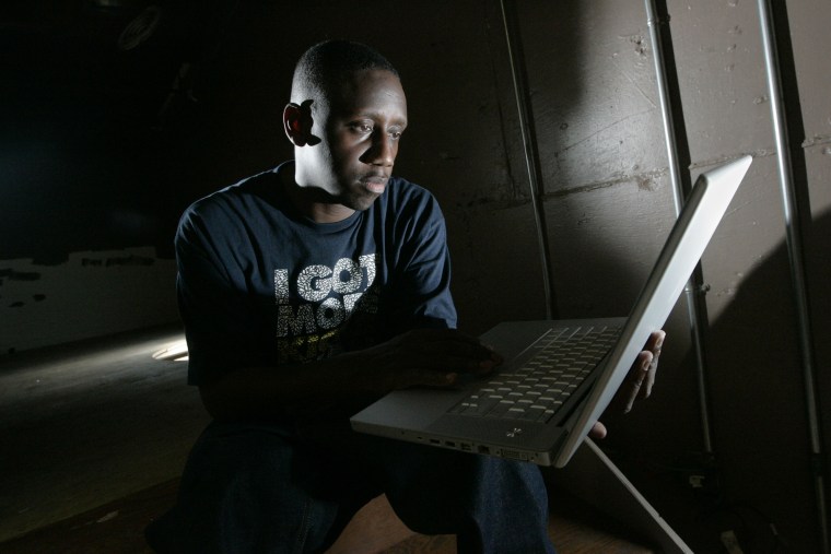 Record producer Chaka Zulu looks through material created by his artists to post to YouTube on Sept. 2, 2008, in Atlanta.