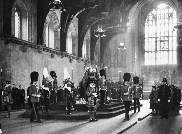 Members of the public pass the coffin of Britain's King George VI, as it lays in state, and the guard is changed in total silence, in Westminster Hall, London, on Feb. 13, 1952.