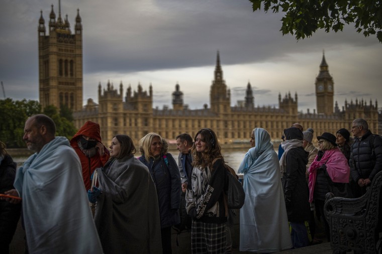 Image: People queue to pay their respects to the late Queen Elizabeth II during the Lying-in State, outside Westminster Hall in London on Sept. 18, 2022.