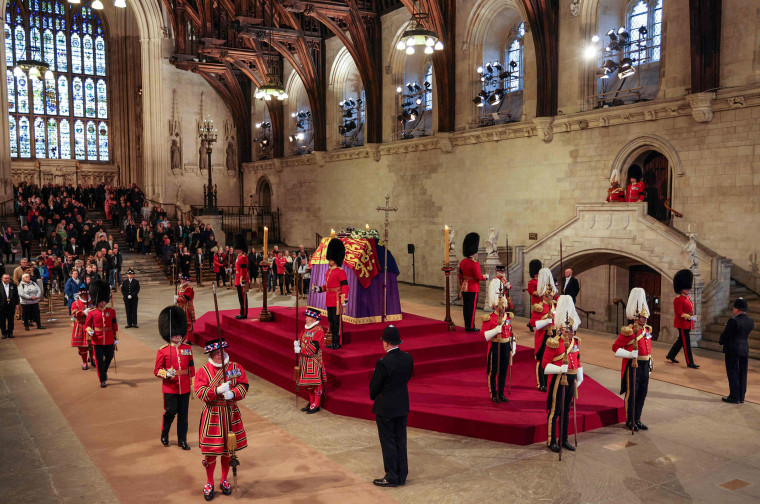 Image: The King's Body Guard, formed of Gentlemen at Arms, Yeomen of the Guard and Scots Guards, change guard duties around the coffin of Queen Elizabeth II, lying in state inside Westminster Hall in London on Sept. 18, 2022.
