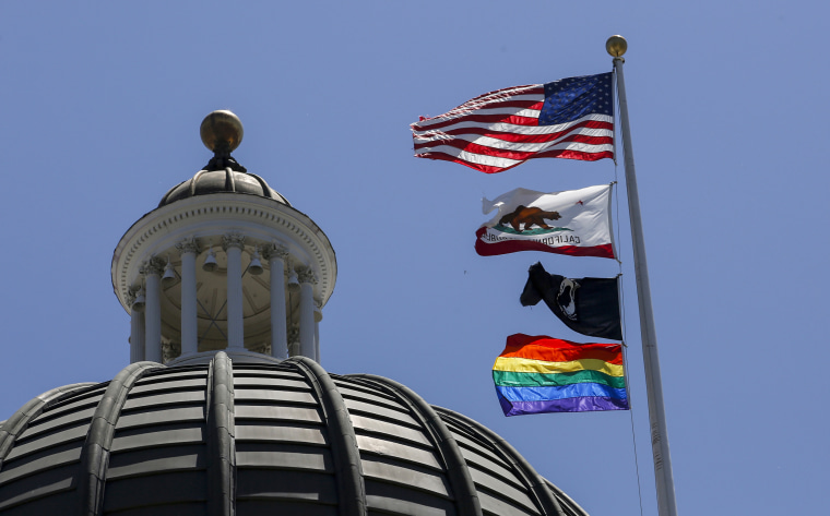 The rainbow Pride flag flutters from the flag pole at the state Capitol in Sacramento, Calif., on June 17, 2019.
