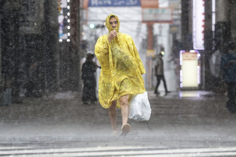 Image: A man makes his way through the heavy rain caused by a powerful typhoon in Kagoshima, southern Japan, on Sept. 18, 2022.
