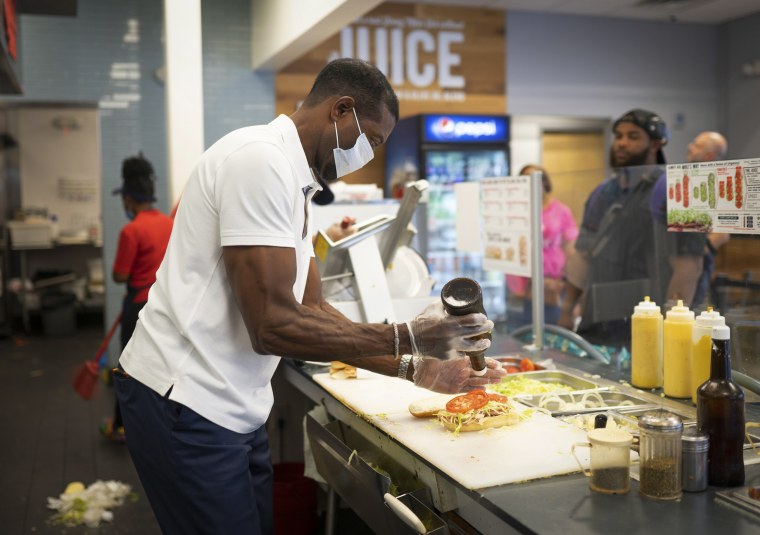 Keith Millner, co-owner of Jersey Mike's sandwich shop in Atlanta, works behind the counter on Sept. 17, 2022.