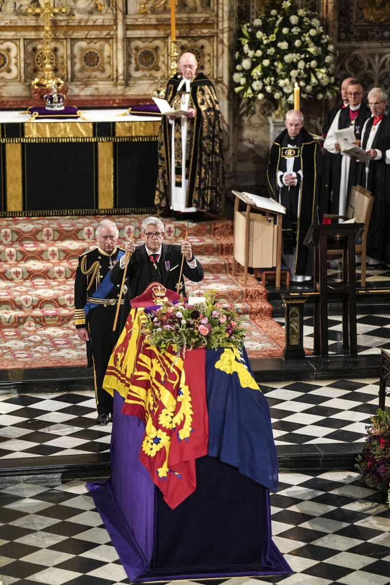 Image: King Charles II, left, watches as The Lord Chamberlain Baron Parker breaks his Wand of Office, marking the end of his service to the sovereign, during a committal service for Queen Elizabeth II at St George's Chapel, Windsor Castle, in Windsor, England, on Sept. 19, 2022.